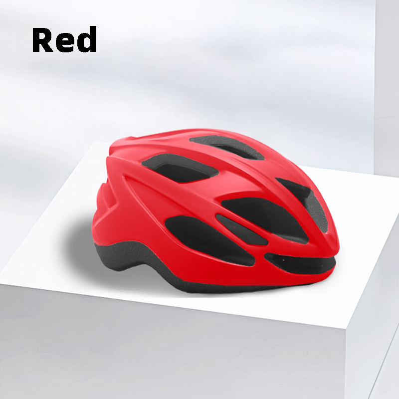 Bright red road cycling helmet with streamlined vents placed on a white platform